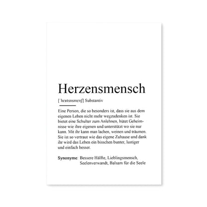 Postkarte mit Definition des Begriffs Herzensmensch von Kamewi. Schwarzer Text auf weißem Papier. Postkarte abgebildet vor weißem Hintergrund.